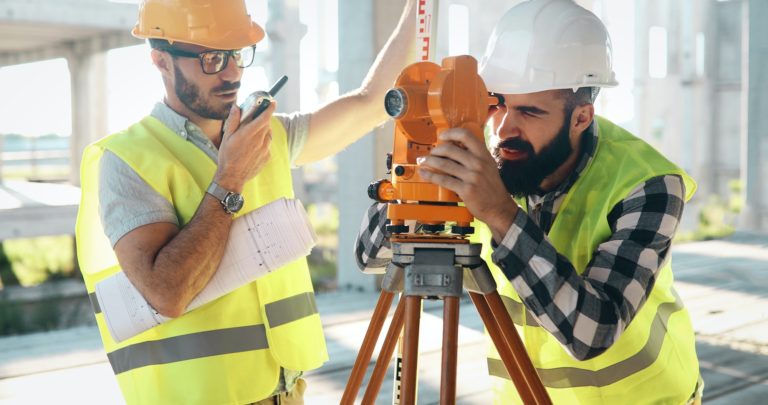 Portrait of construction engineers working on building site