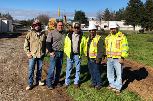 A group of cement masons stand together to represent a lifelong career